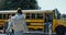 Group students running boarding schoolbus. Pupils rushing to public shuttle.