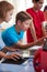 Group Of Students In After School Computer Coding Class Learning To Program Robot Vehicle