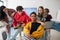 Group of students sitting and posing together in robotics classroom