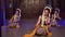 a group of Sundanese dancers dance in a sitting position at a monastery