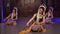 a group of Sundanese dancers dance in a sitting position at a monastery