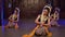 a group of Sundanese dancers dance in a sitting position at a monastery