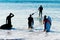 Group surfers going  surf SIlhouette