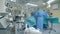 A group of surgeons is performing an operation in a medical unit