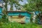 A group of swarm of bees on an old wooden beehive in a farm garden. Apiary, swarm, sheltered from the wind and with a good stay