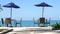 Group of tables and chairs on a breezy beach.