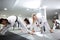 Group of taekwondo athletes stretching and training together with their physically disabled friend