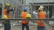 Group team of young asian contractor and worker wearing hardhat walking to construction site with professional.