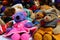 A group of teddy bears of different colors and sizes wearing crocheted clothes. They look cuddly, adorable