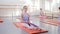 Group of teen girls do exercise at ballet gymnastics class in dance school.