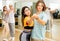 Group of teenage boys and girls training slow foxtrot movements in dance studio