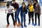 Group of teenage friends ice skating on an ice rink