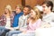 Group Of Teenage Friends Sitting On Sofa At Home