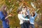 Group Of Teenage Friends Throwing Leaves In Autumn