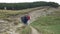 Group of teenage friends walking along hiking trail path enjoying the mountain trip and cows nature landscape -