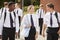 Group Of Teenage Students In Uniform Outside School Buildings