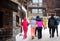 Group of teenager tourists walking on street of mountain resort town in Switzerland, Europe. Winter vacation. Ski resort