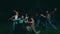 a group of teenagers dance together while wearing jeans and throw colored powders in the air