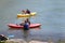 A group of teenagers kayaking on the Snake River.