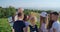 Group of teenagers with male instructor looking on map in mountains.