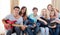 Group of teenagers playing guitar at home