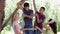 Group Of Teenagers Playing On Rope Ladder