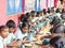 Group of teenagers pupils being served Meal plate of rice In government School Canteen. Unhealthy food for poor children