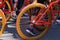 A group of teenagers using bicycles of the same type are gathering.