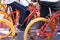 A group of teenagers using bicycles of the same type are gathering.