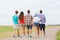 Group of teenagers walking outdoors from back