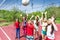 Group of teens playing volleyball near the net