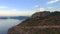 Group of telecommunication antennas on top of mountain hill and sea view. Aerial view 4K.