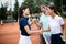 Group of tennis player handshaking after playing a tennis match. Fairplay, sport concept.