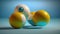 a group of three balls sitting on top of a blue tablecloth covered floor next to a blue wall and a blue wall behind them.