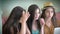 Group of three beautiful girlfriends look at laptop screen talk social networking with friends have fun