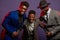 A group of three black men in stylish suits posing  in studio