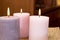 Group of three burning candles in the home. Candles of pink tones in a warm house