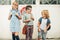 Group of three funny kids wearing backpacks walking back to school