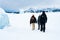 Group of three hikers trekking on the snow in Matanuska Glacier, Alaska.