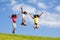 Group three jumping girls over clean blue sky