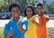 Group of three laughing african american young adults showing thumbs