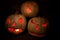 Group of three lit white jack o\'lanterns