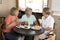 Group of three lovely middle age senior mature women girlfriends meeting for coffee and tea with cakes at coffee shop sharing time