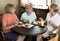 Group of three lovely middle age senior mature women girlfriends meeting for coffee and tea with cakes at coffee shop sharing time