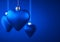 Group of three matt blue Christmas ornaments in heart shape