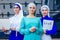 Group of three muslim businesswomen caucasian woman in stylish hijab and turban working on the street office background