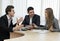 Group of three people having discussion