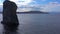 A group of three pillar-like rocks protruding from the water