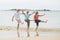 Group of three senior mature retired women on their 60s having fun enjoying together happy walking on the beach smiling playful