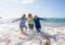 Group of three senior women laughing as falling down in the water on beach. Humor senior health